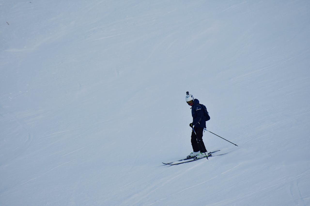 about-06 A skier navigating a snowy slope, showcasing winter sports and seasonal recreation.
